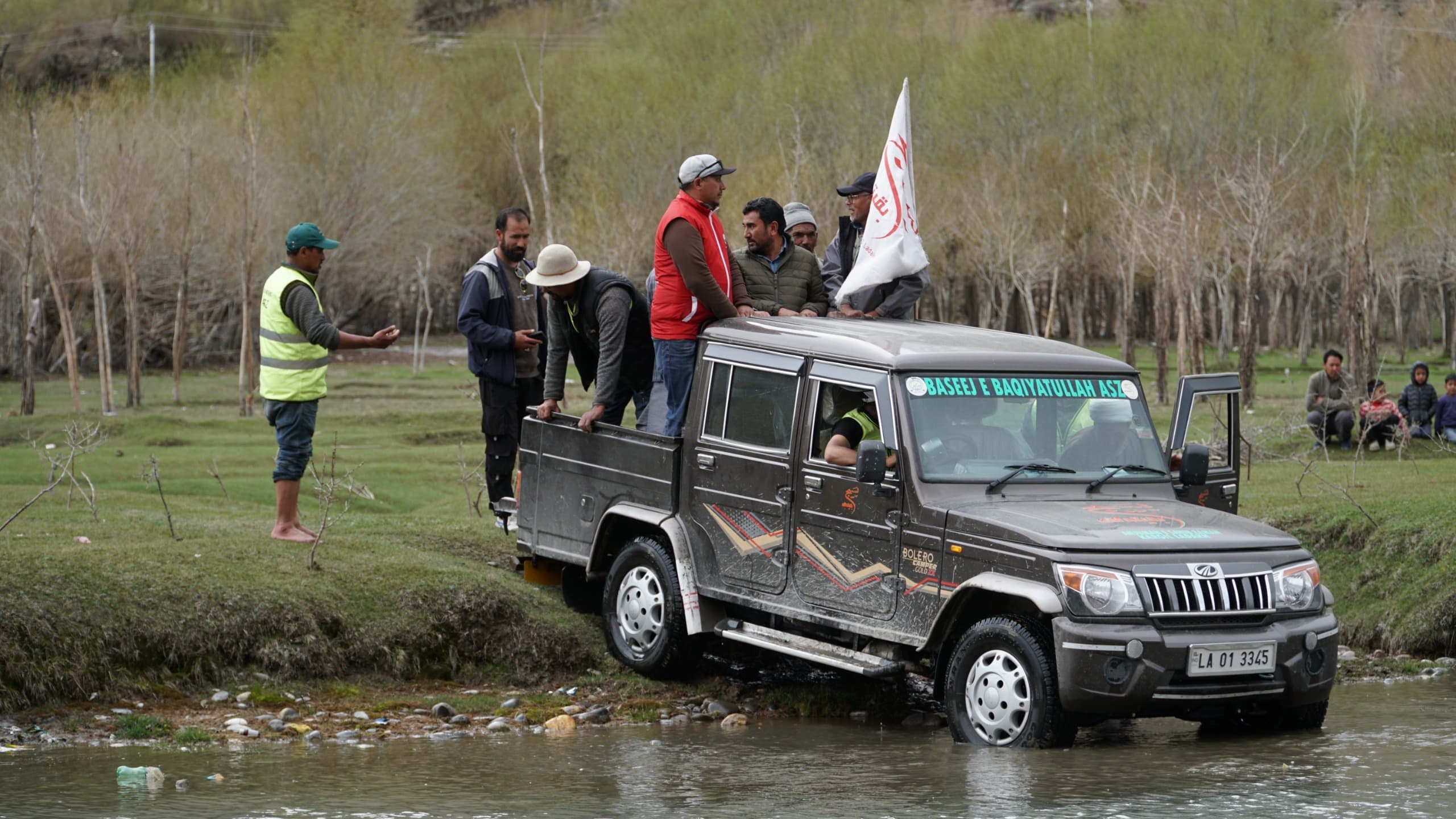 Crossing the river to reach the plantation site